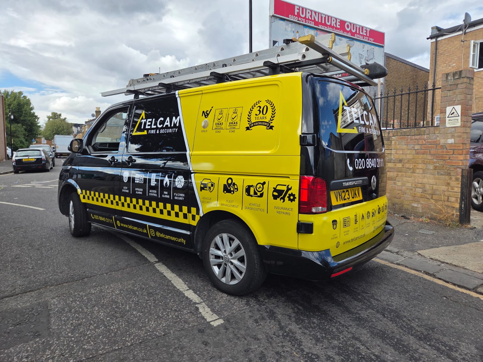 Black and yellow Telcam Fire & Security van with full branded graphics